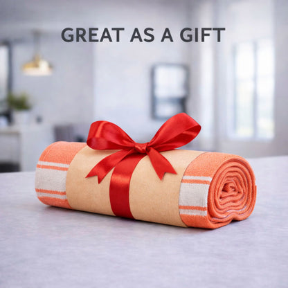 Gift-ready rolled amethyst purple bath towel with band and red ribbon bow, great as a gift