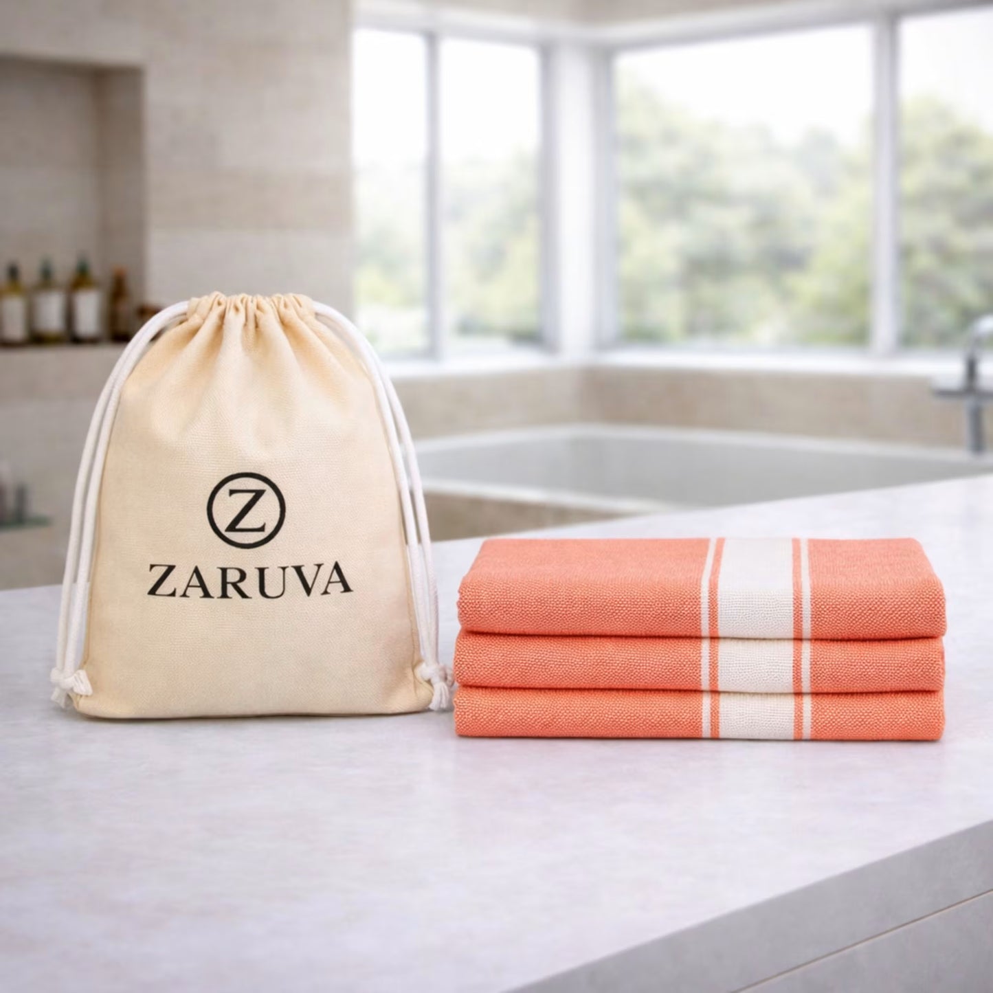 Zaruva bamboo cotton bath towel (orange) set of 3 folded with ZARUVA logo pouch on bathroom counter, 75x150 cm