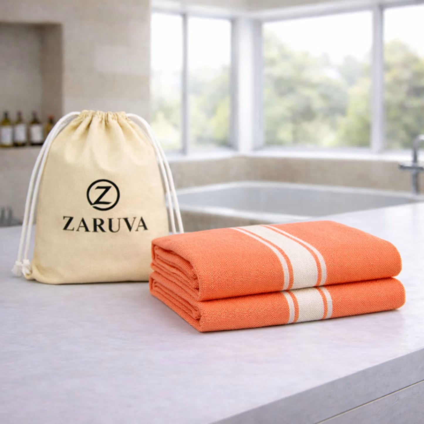 zaruva bamboo cotton bath towel set of 2 folded on bathroom countertop with branded drawstring pouch, quick dry and soft