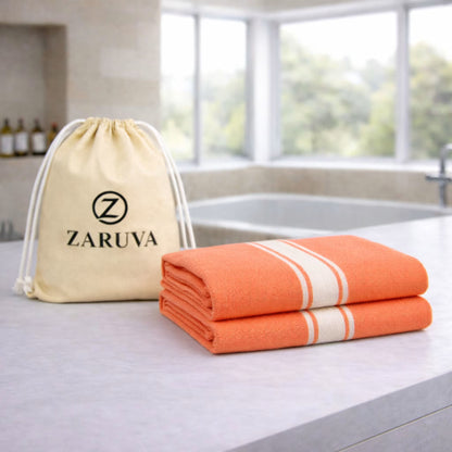 zaruva bamboo cotton bath towel set of 2 folded on bathroom countertop with branded drawstring pouch, quick dry and soft